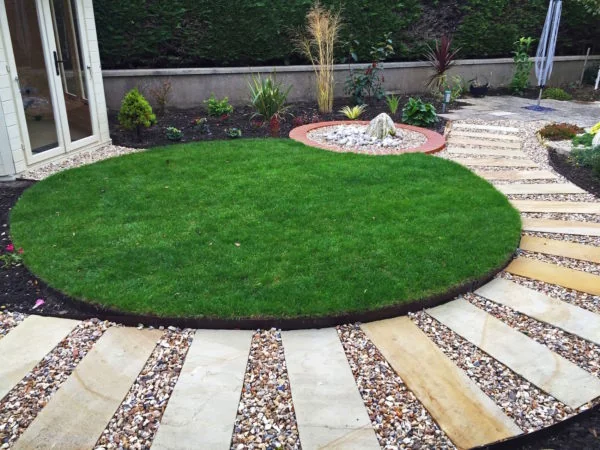 Paved garden pathway with gravel across a Cotswold garden