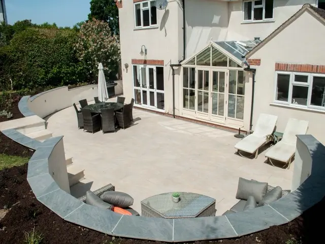 Harp Hill hillside transformation with curved retaining wall